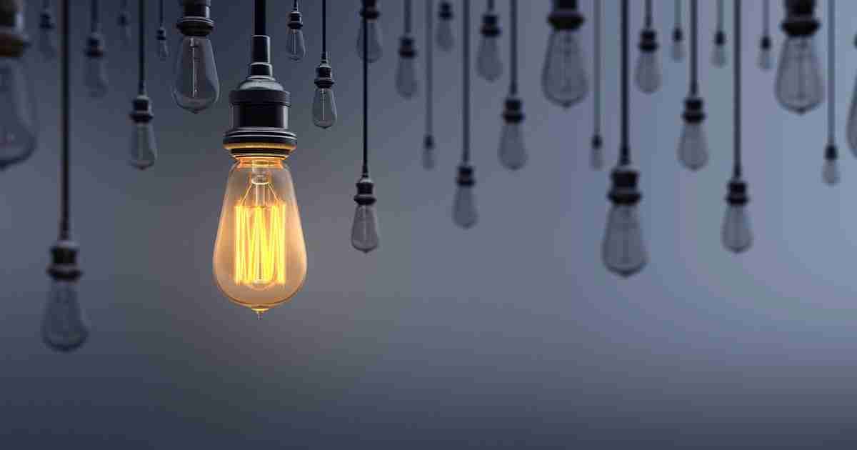 Glowing Light Bulb Standing Out From the Crowd